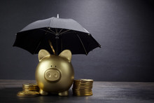 Gold Piggy Bank With Umbrella Concept For Finance Insurance, Protection, Safe Investment Or Banking