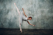 Ballerina in ballroom. Young beautiful female ballet dancer, dressed in professional outfit, pointe shoes and white tutu.