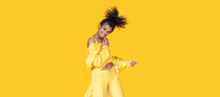 Playful Happy Young African Woman Wear Stylish Yellow Clothes Look At Camera Dancing Funky Black Teen Fashion Girl On Summer Studio Background, Horizontal Banner Header Website Design, Copy Space