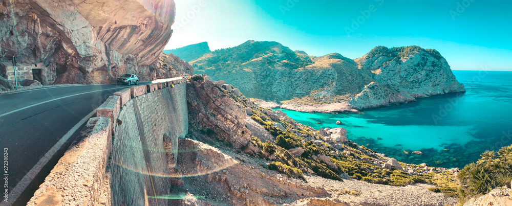 Obraz na płótnie Landscape view of the mountain coastline with turquoise blue water and idyllic beaches and colorful sunset light. Serra de Tramuntana, Cap de Formentor, Mallorca, Spain w salonie