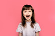 © Marharyta Hanhalo - Wow. Crazy good news. Image of overjoyed excited screaming amazed little child girl standing isolated over pink background. Looking camera with open mouth.