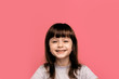 © Marharyta Hanhalo - Stylish girl with pretty face on pink background. Hairdresser, skincare, casual style, denim. Little girl with long dark hair. Beauty and kid fashion with healthy hair. Happy lifestyle