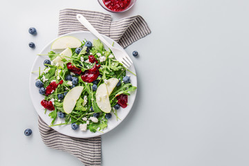 Summer salad with salad leaves, fruits, berries and cheese