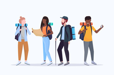 group tourists hikers with backpacks holding compass and travel map searching direction hiking conce