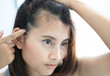 © mraoraor - Woman looking reflection in the mirror serious hair loss problem for health care shampoo and beauty product concept