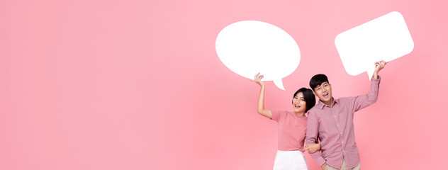 Happy smiling young Asian couple with speech bubbles