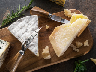 Wall Mural - Cheese platter with Parmesan and blue cheese on stone background. Top view.