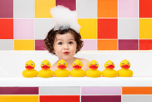 Happy Toddler In Bathtub Playing With Rubber Ducks Making Duck Face