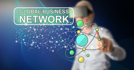 Wall Mural - Man touching a global business network concept