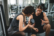 Fitness woman with personal trainer at gym.
