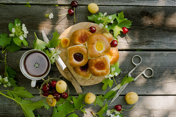 Baking with fruit filling over wood rustic background with cherry and apricot, Food still Life