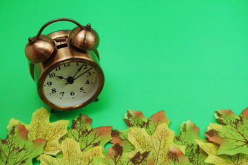 Alarm clock with Maple leaf boder on green background