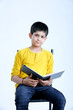 © PRASANNAPIX - young indin boy holding a notebook
