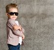 © FAB.1 - Image of cheerful excited little boy child standing isolated over concrete wall.