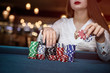 © RomanR - Female hand taking poker chips from pile