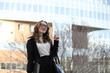 © alexkich - Business lady in strict clothes on the background of buildings