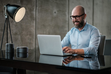 Middle-aged designer working in office