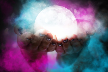 Wall Mural - glowing moon at the hands of a woman. magical glow, smoke, neon light