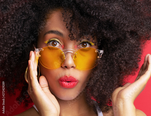 Dark Skinned Model With Curly Black Hair In Orange Glasses On A