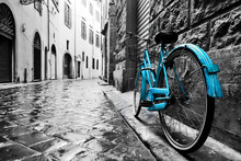 Retro Blue Bike On Old Town Street.