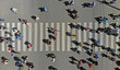 Aerial. People crowd on pedestrian crosswalk. Top view.