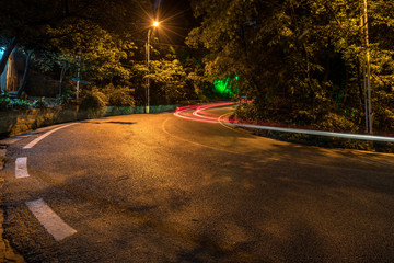 Wall Mural - Abstract image of blur motion of car on forest road at night