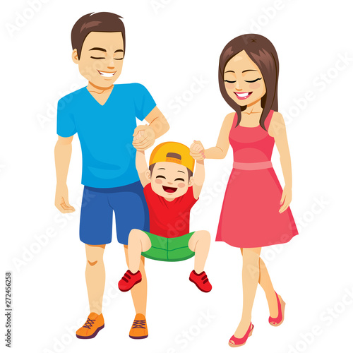 Family walking with toddler boy father and mother holding son hands