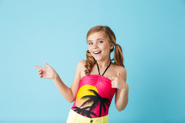 Cheerful little girl wearing swimsuit standing isolated