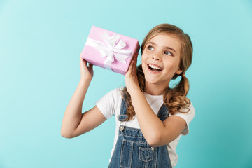 Wall Mural - Portrait of a cheerful little girl isolated