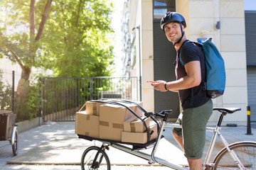 Wall Mural - Bicycle messenger making a delivery on a cargo bike