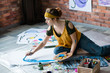 © golubovy - Art relaxation. Young lady sitting on floor, enjoying painting abstract artworks.