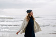 © Bonninstudio/Stocksy - Woman enjoying on the beach in winter day.