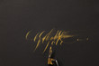 © Luca Di Lotti/Stocksy - the word ''Gold'' hand-written with golden ink and a nib mounted on a oblique holder