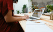 © Bonninstudio/Stocksy - Anonymous businesswoman typing on laptop.