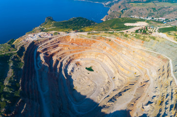 Aerial view of opencast mining quarry with lots of machinery at work - view from above.