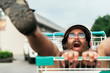 © Santi Nunez/Stocksy - Funny bearded hipster enjoying in the street.