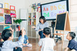 © MaaHoo Studio/Stocksy - Teacher and preschool kids in classroom
