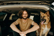 © Joe+Kathrina/Stocksy - guy sitting in car with dog
