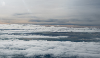 Clouds seen from an airplane, blue sunshine, soil background nature landscape