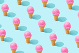 Fototapeta Kwiaty - Trendy sunlight Summer pattern made with pink strawberry ice cream on bright light blue background. Minimal summer concept.