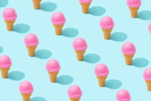 Trendy Sunlight Summer Pattern Made With Pink Strawberry Ice Cream On Bright Light Blue Background. Minimal Summer Concept.