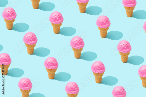 Plakat Trendy sunlight Summer pattern made with pink strawberry ice cream on bright light blue background. Minimal summer concept.