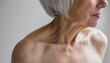 © Rob and Julia Campbell/Stocksy - Senior topless woman on simple grey background