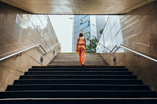 Woman Walking Up The Stairs In The Underpass, Horizontal