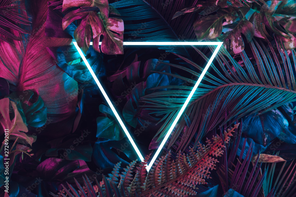 Creative fluorescent color layout made of tropical leaves. Flat lay neon colors. Nature concept. - obrazy, fototapety, plakaty 