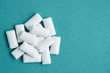 top view of heap of chewing gums on blue background, copy space