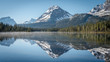 © Travelpix/Stocksy - Fog stillness and reflection.  Sunrise at Bow Lake.  Rockies.  Canada