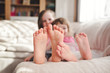 © Lea Csontos/Stocksy - Siblings having fun and showing their feet