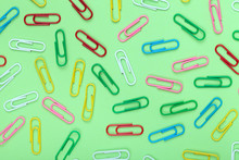 Colorful Paper Clips On Green