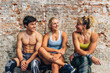 © MyMicrostock/Stocksy - Athletes chatting on bench